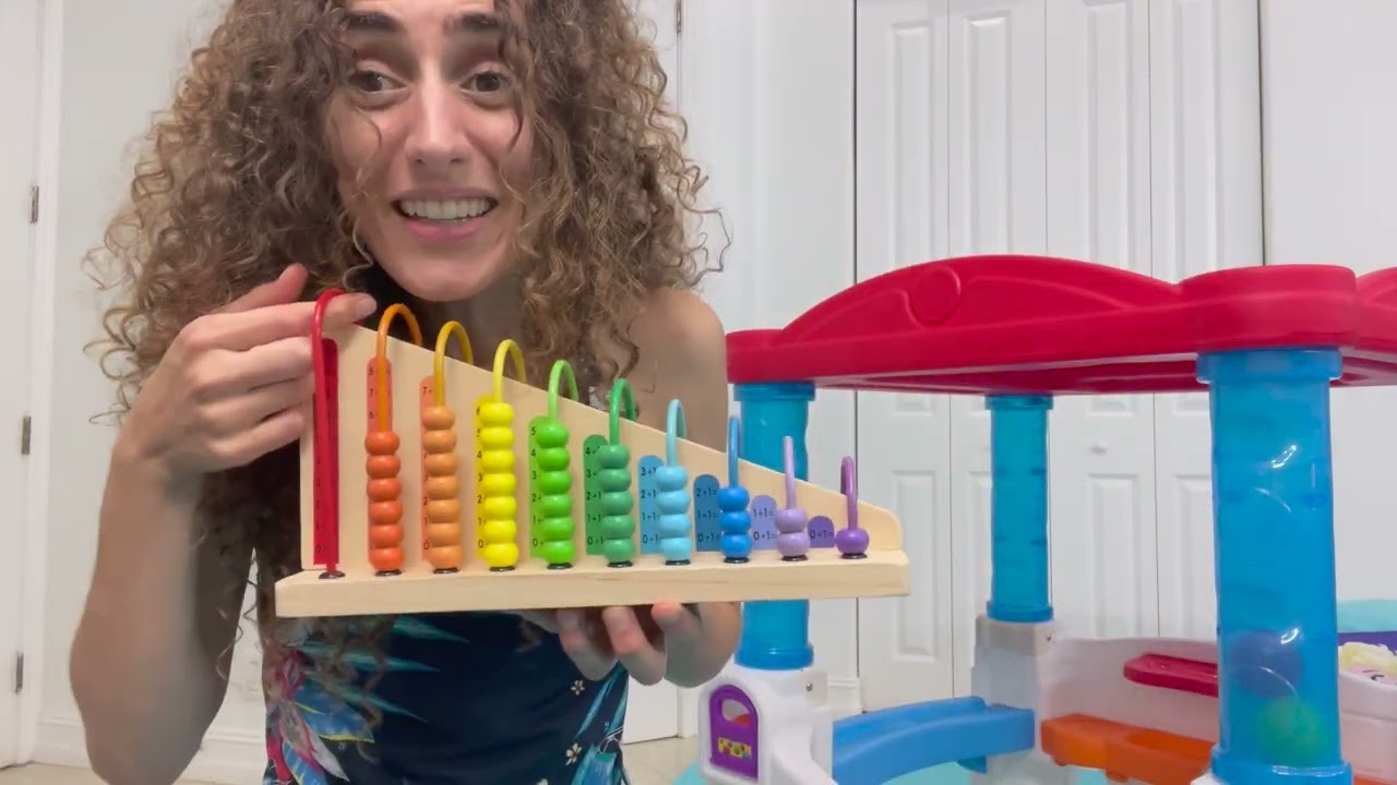 Mama Mimi teaching with educational tools